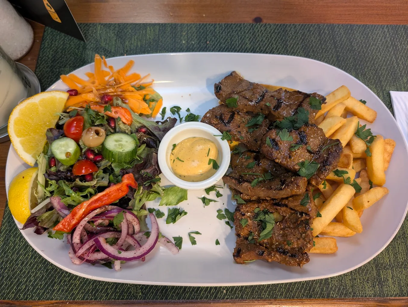 Charcoal grilled lamb platter with chips and Mediterranean salad