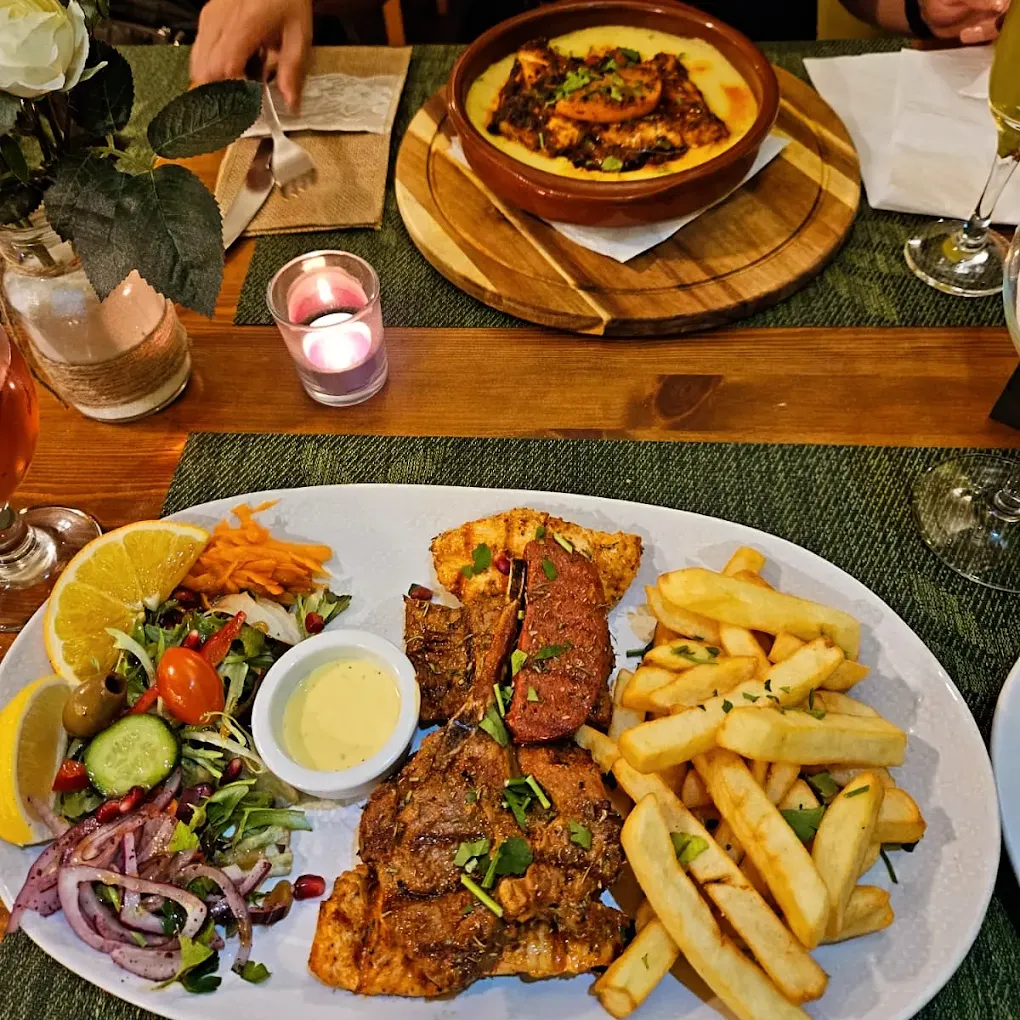 Mixed grill main course served with sides and starter at Olive Tree