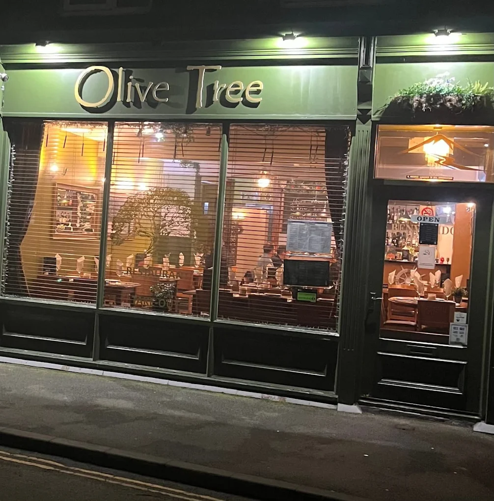 Warm interior of Olive Tree Restaurant in Buxton at night